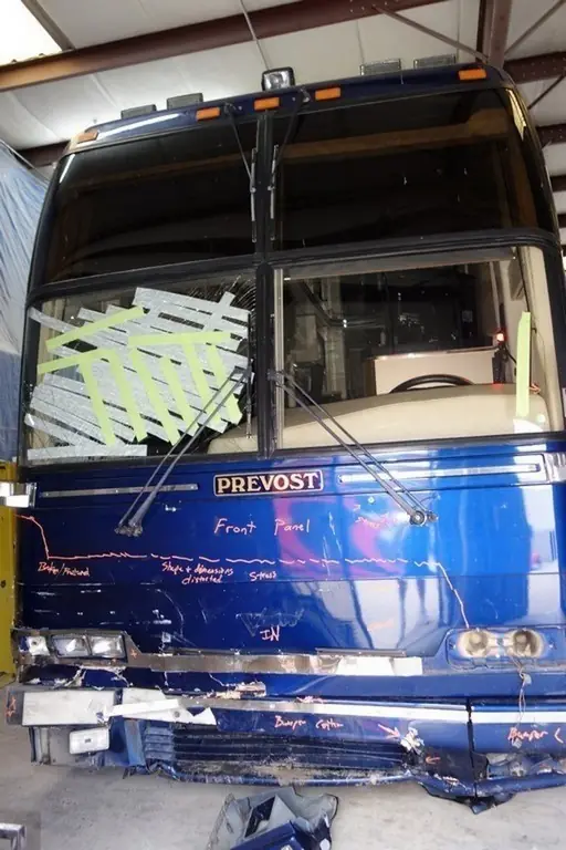Blue 1997 Prevost H3-45 Featherlite with front-end collision damage before repair at Excalibur Coach