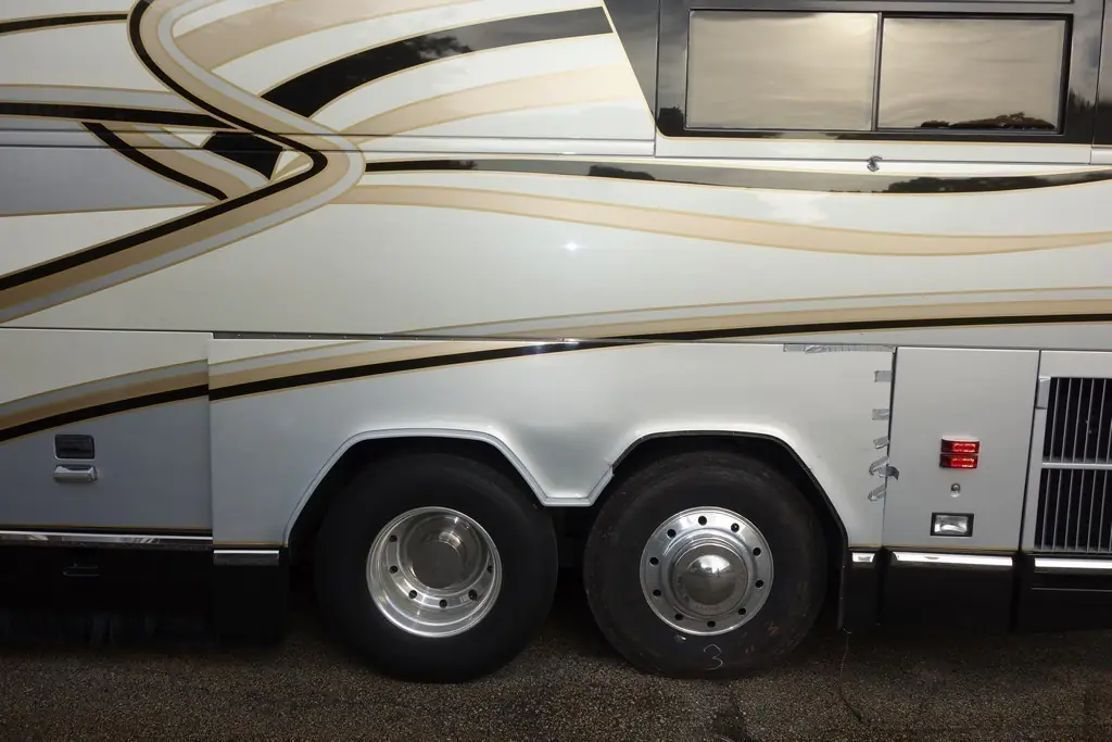 Prevost H3-45 driver-side fender repaired and repainted after a tire blow-out by Excalibur Coach
