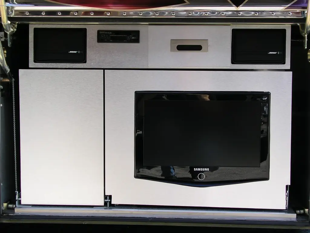 Exterior bay cabinet with built-in television designed by Excalibur Coach