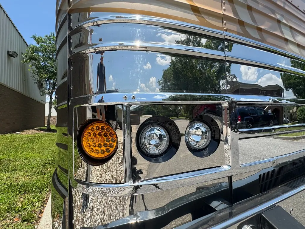 Polished stainless front detail and headlights of the 1999 Vogue Prevost XL